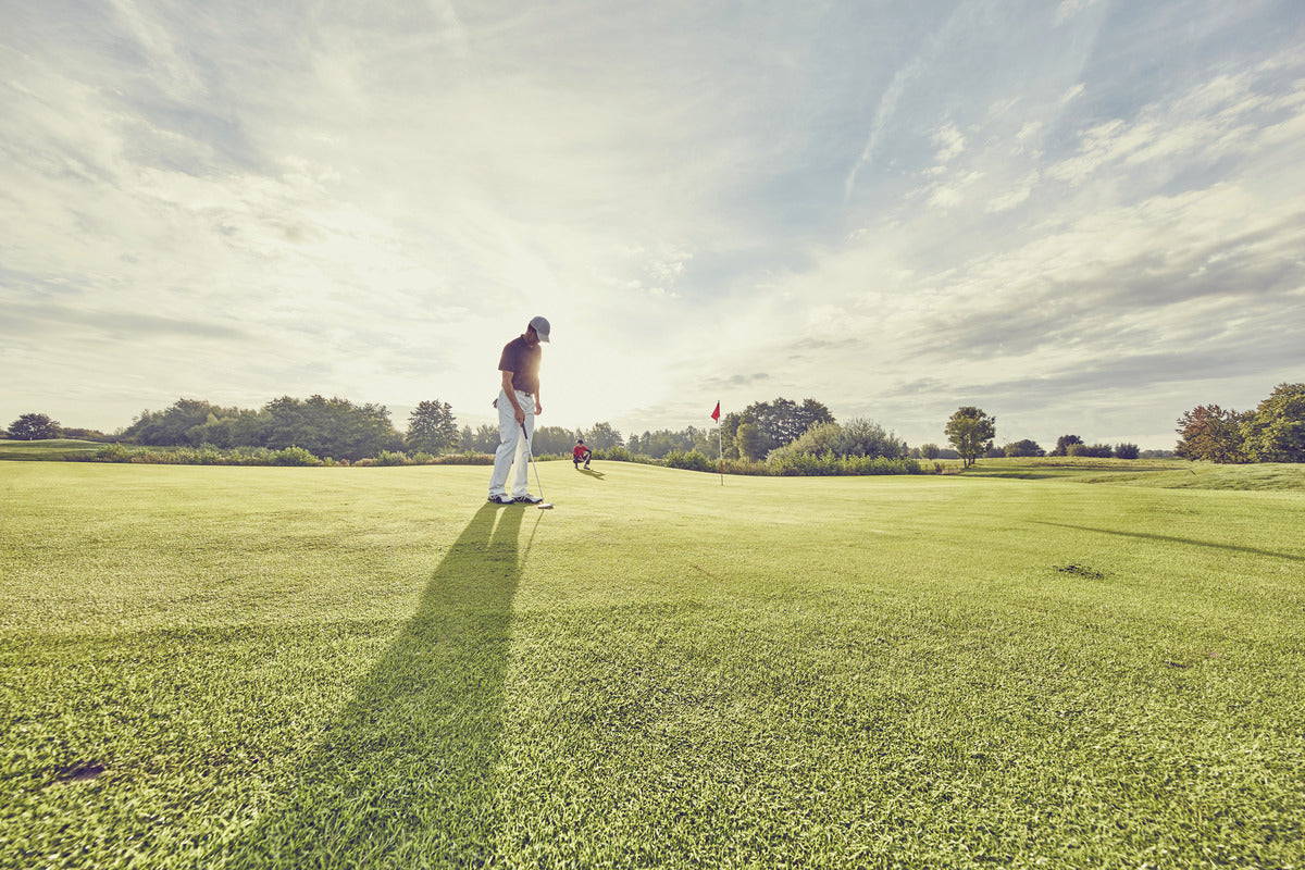 A golfer enjoying a high-performance round on a premium golf course with smooth fairways and scenic views.
