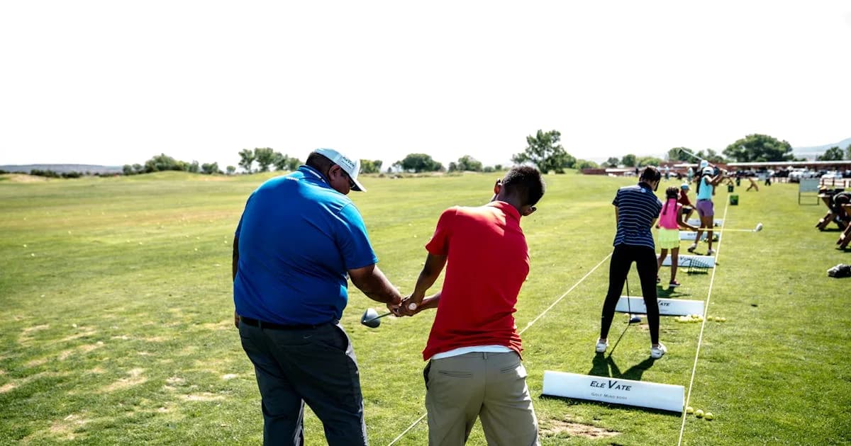 Golf instructor teaching a group of beginners on an outdoor course
