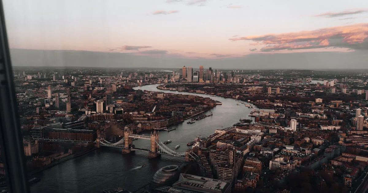 Aerial view of London's skyline with Tower Bridge and the River Thames at sunset