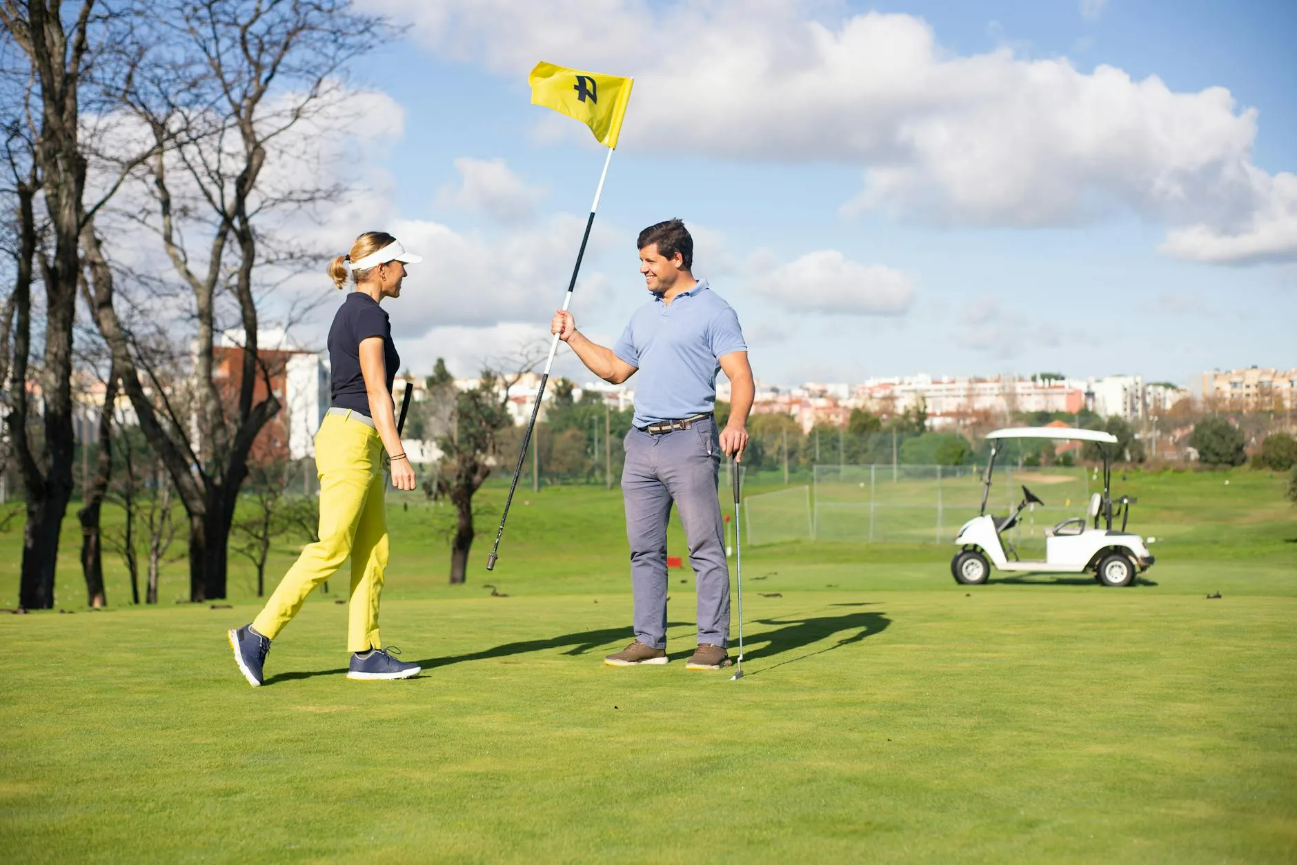 Two golfers sharing a laugh on the fairway during a sunny round