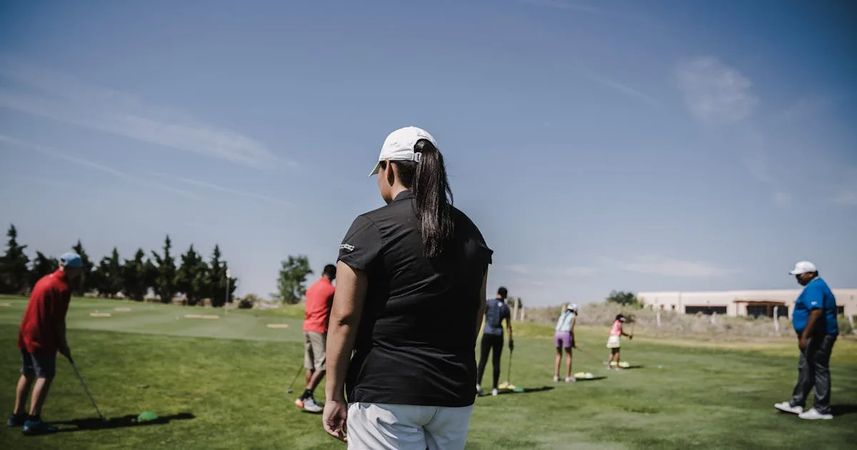 A golfer mid-swing on a well-kept fairway with trees lining the course