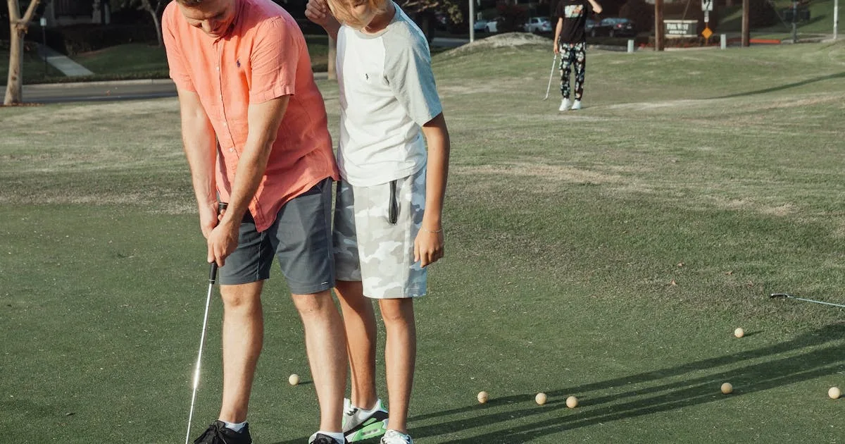 A father and son enjoying bonding time practising golf on a sunny day