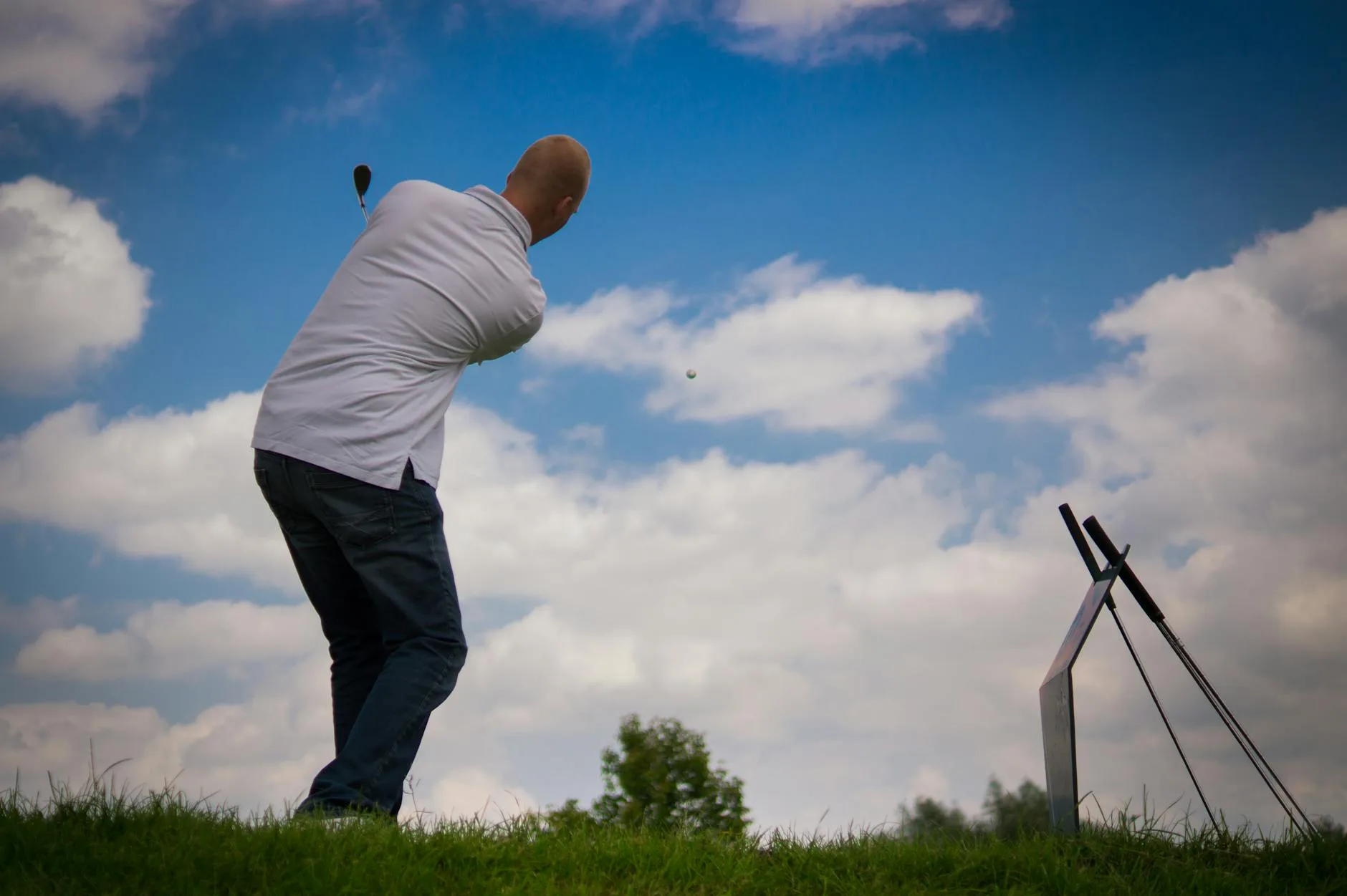 A golfer stretching on the practice range before a round